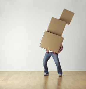 A man juggling with heavy moving boxes - This is more or less what your DIY move would look like